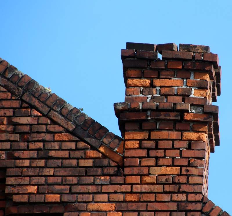 Signs Your Hudson Mills Home Needs a Chimney Inspection Damaged chimney on an Hudson Mills home showing cracks and missing mortar